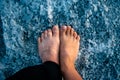 Female And Male Bare Feet Are Standing On A Salty Surface