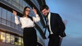 Female and male business people dancing enjoying the music by office building. Royalty Free Stock Photo