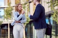 Female and male cowokers talking outiside Royalty Free Stock Photo