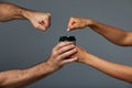 Female and male hand mock paper cup with tea or coffee drink, on isolate gray background. Gray background, copy space