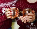 Female and male hands with glass cup of delicious Christmas mulled wine Royalty Free Stock Photo