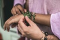 Female and male hands with hippie wristlets