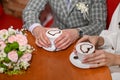 female and male hands hold a cup of cappuccino coffee with foam with a heart pattern. Royalty Free Stock Photo