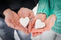 Female and male hands with snow hearts