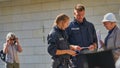 A female and a male policeman help a visitor at the open day of the parliament of Lower Saxony