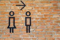 Female Male restroom. Sex symbol on red brick wall .. Toilet icon, Restroom Concept Royalty Free Stock Photo