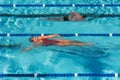 Female and male sharing laps swimming pool for fitness