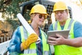 Female and Male Workers With Blueprints and Computer Tablet Royalty Free Stock Photo