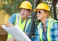 Female and Male Workers With Technical Blueprints Talking Royalty Free Stock Photo