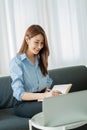 Asian businesswoman working with tiger skins notebooks graphs documents at modern desks using computers successful female e-commer