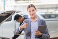 Female manager and car mechanic while working in auto repair shop, Young business woman with digital tablet showing thumbs up, Car Royalty Free Stock Photo