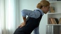 Female manager feeling sharp pain in loins, sedentary life on work result