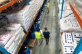 Female manager and male worker discussing over clipboard in warehouse Royalty Free Stock Photo