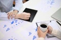 A female manager sipping coffee while working on financial data on report with her assistant Royalty Free Stock Photo