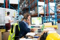 Female manager talking on mobile phone at desk Royalty Free Stock Photo