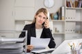 Female manager talking on phone in office Royalty Free Stock Photo