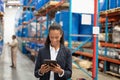 Female manager using digital tablet in warehouse Royalty Free Stock Photo