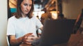 Female manager using laptop at cafe workplace, girl freelancer writing on keyboard in cafe interior, businesswoman working