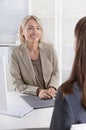 Female managing director in a job interview with a young woman. Royalty Free Stock Photo