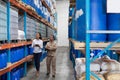 Female manger and male staff interacting with each other while checking stocks