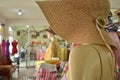 Female manikin with a hat in Thai silk store