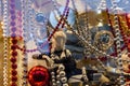 Female mannequin dressed in black lingerie and different christmas decorations in a showcase