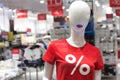 Female mannequin in a red T-shirt with the word percent. White mannequin with red lips. Clothing advertising and sale