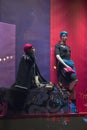 Female mannequins in a shop window and reflected lights