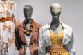 Female mannequins standing in store window display of women casual clothing shop in shopping mall