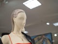 Female mannequins wearing leather jacket and necklace in department store