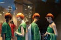 Female mannequins wearing stylish green clothes collection. Dummies in the store window.