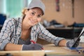 female manual worker in workshop writing notes Royalty Free Stock Photo