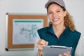 female manual worker writing on clipboard Royalty Free Stock Photo