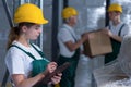 Female manufacturing labourer holding clipboard Royalty Free Stock Photo