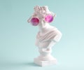 Female marble statue in large pink glasses on blue background. Concept of positive view and lies