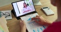 Female marketer discusses a financial report with a colleague during a video call