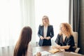 Marketing experts sit around table and looking at woman speaker at meeting. Royalty Free Stock Photo