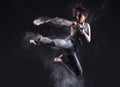 Female Martial Artist with Powder Jump Kick Royalty Free Stock Photo