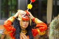 A female mask dancer is going to perform on stage.