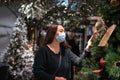 Woman choosing Christmas tree baubles