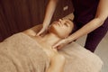 Female masseur pampering neck to young slim woman