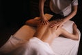 Female masseuse does back massage to young unrecognizable woman