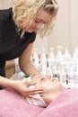 Female masseuse giving client facial Royalty Free Stock Photo