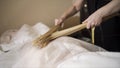 Female masseuse working with woman and performing Japanese massage with bamboo sticks in a spa salon. Action. People Royalty Free Stock Photo