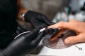 Female master makes a man manicure, nail polishing Royalty Free Stock Photo