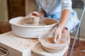 Female master making a pot on pottery wheel