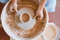 Master making a pot on pottery wheel, top view