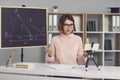 Female math and geometry teacher explains new material to students through a video call.