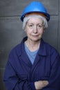 Female mature technician wearing a blue hard hat and a uniform Royalty Free Stock Photo