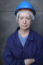 Female mature technician wearing a blue hard hat and a uniform Royalty Free Stock Photo